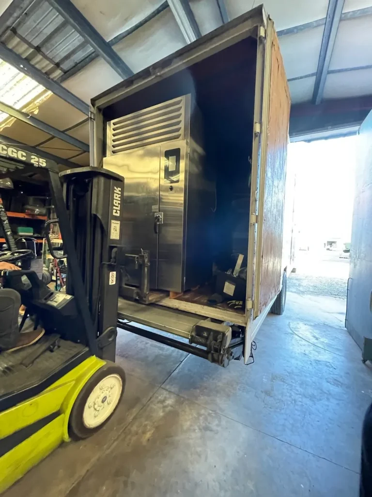 Tropic crew completing a commercial oven delivery
