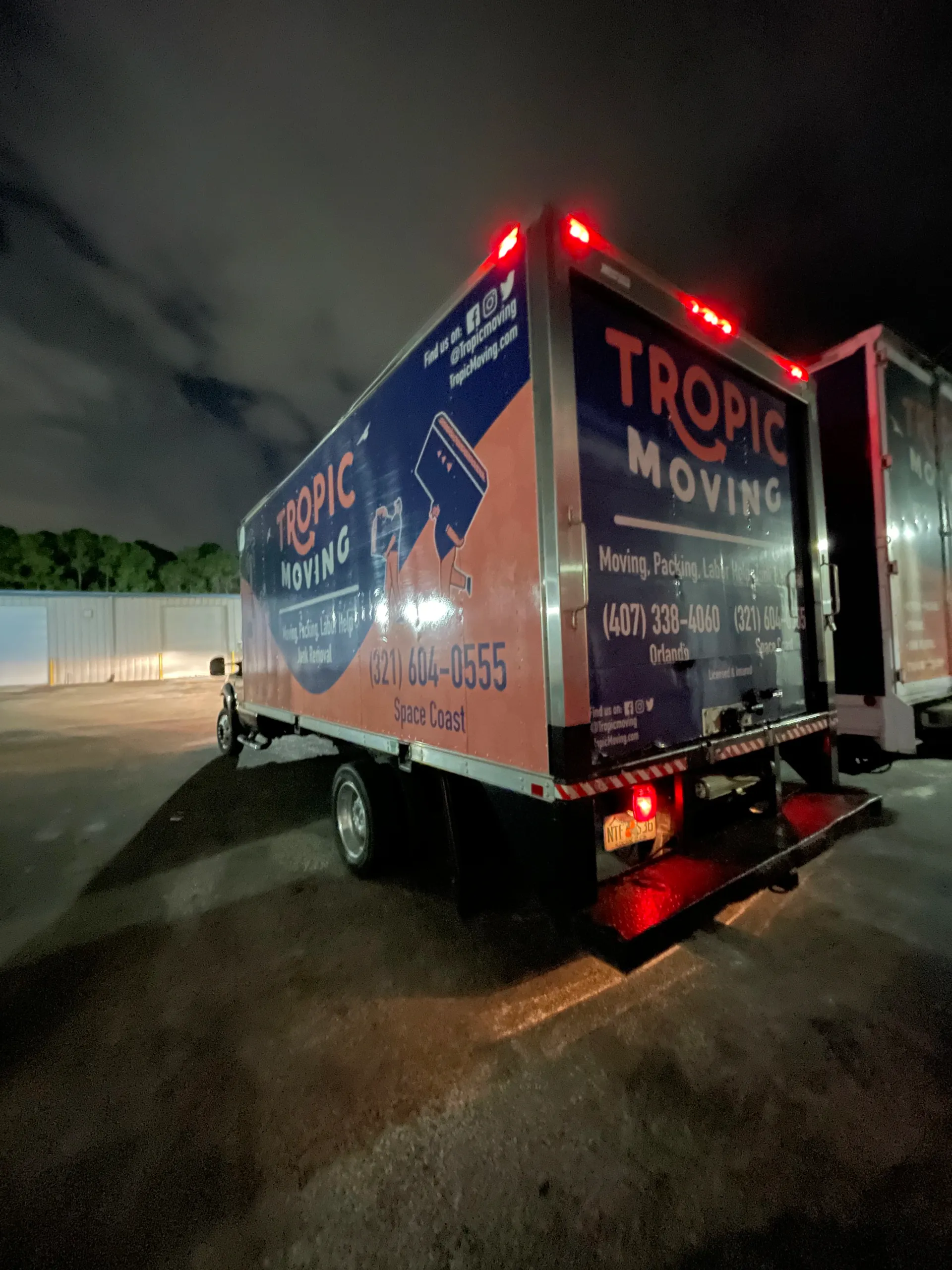 Tropic Moving trucks outside a commercial facility